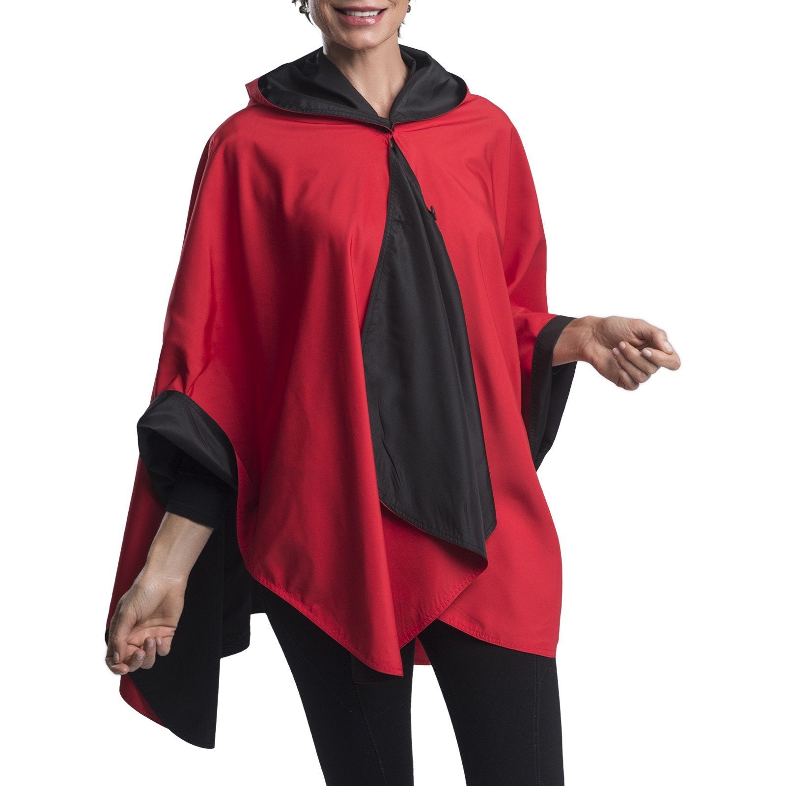 Women wearing a Black & Red RainCaper travel cape with the Black side out, revealing the Red color at the lapels and cuffs