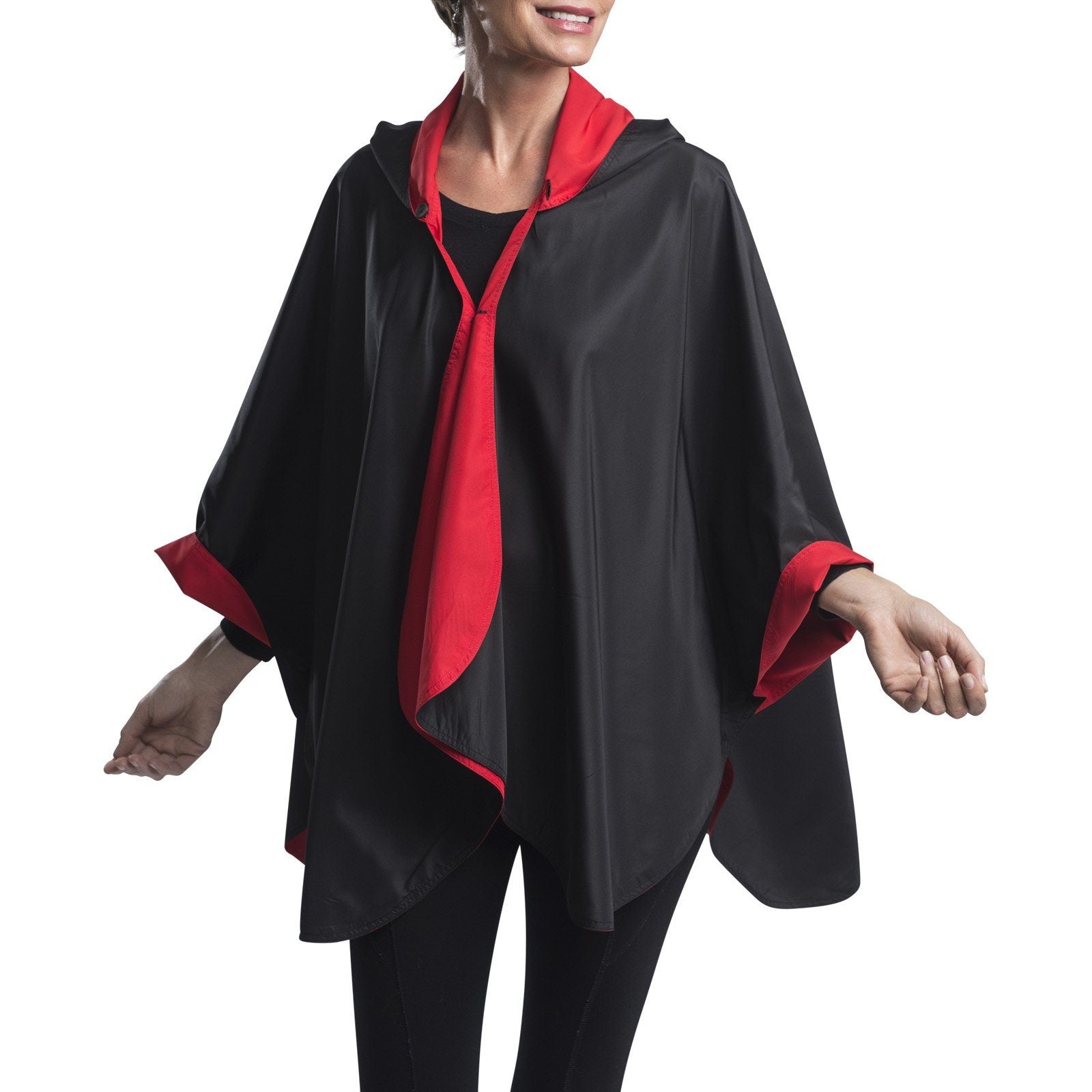 Women wearing a Black & Red RainCaper travel cape with the Black side out, revealing the Red color at the lapels and cuffs