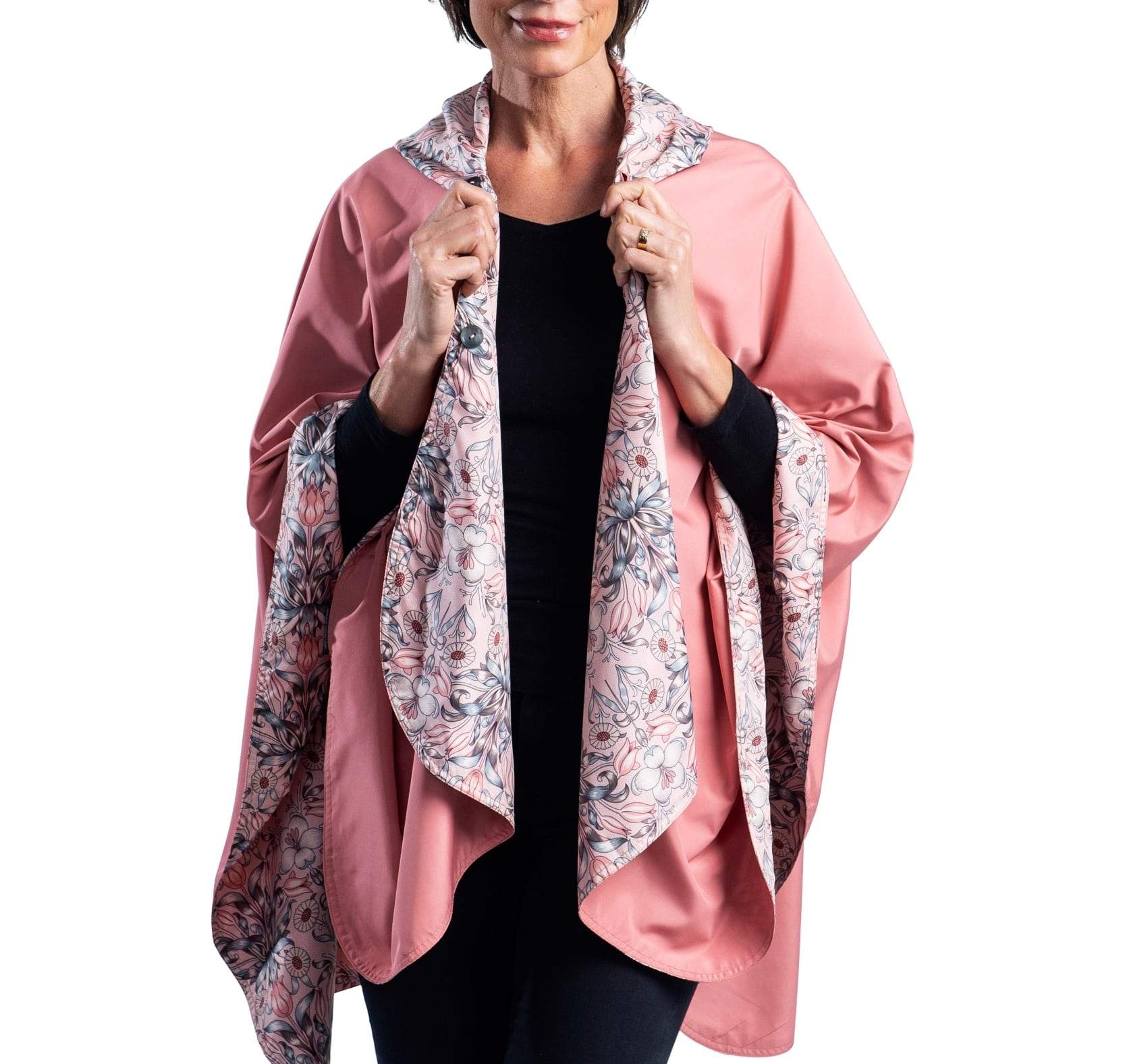 Women wearing a Blush & William Morris "Tulips" RainCaper travel cape with the Blush side out, revealing the William Morris "Tulips" print at the lapels and cuffs