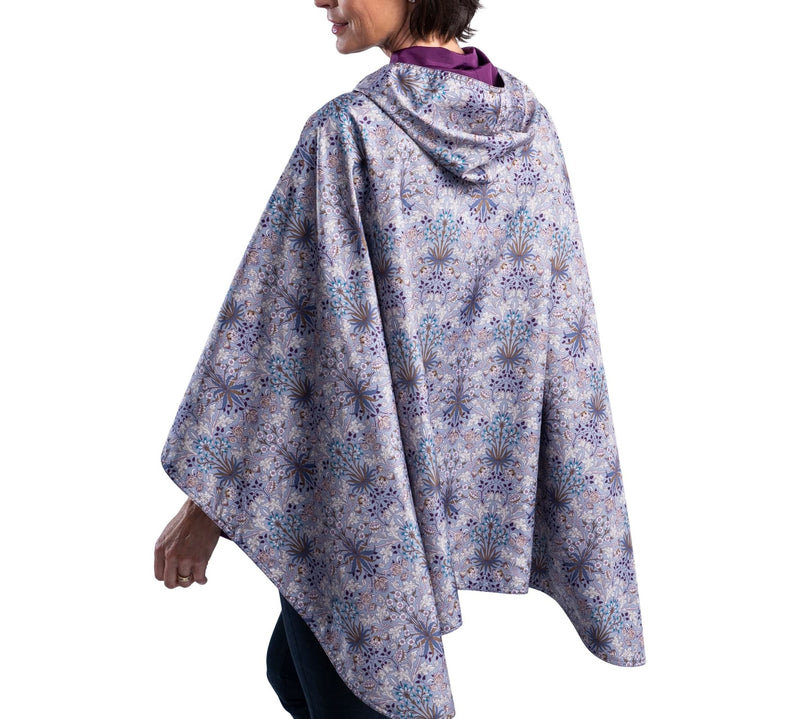 Women wearing a Plum/William Morris Hyacinth RainCaper travel cape