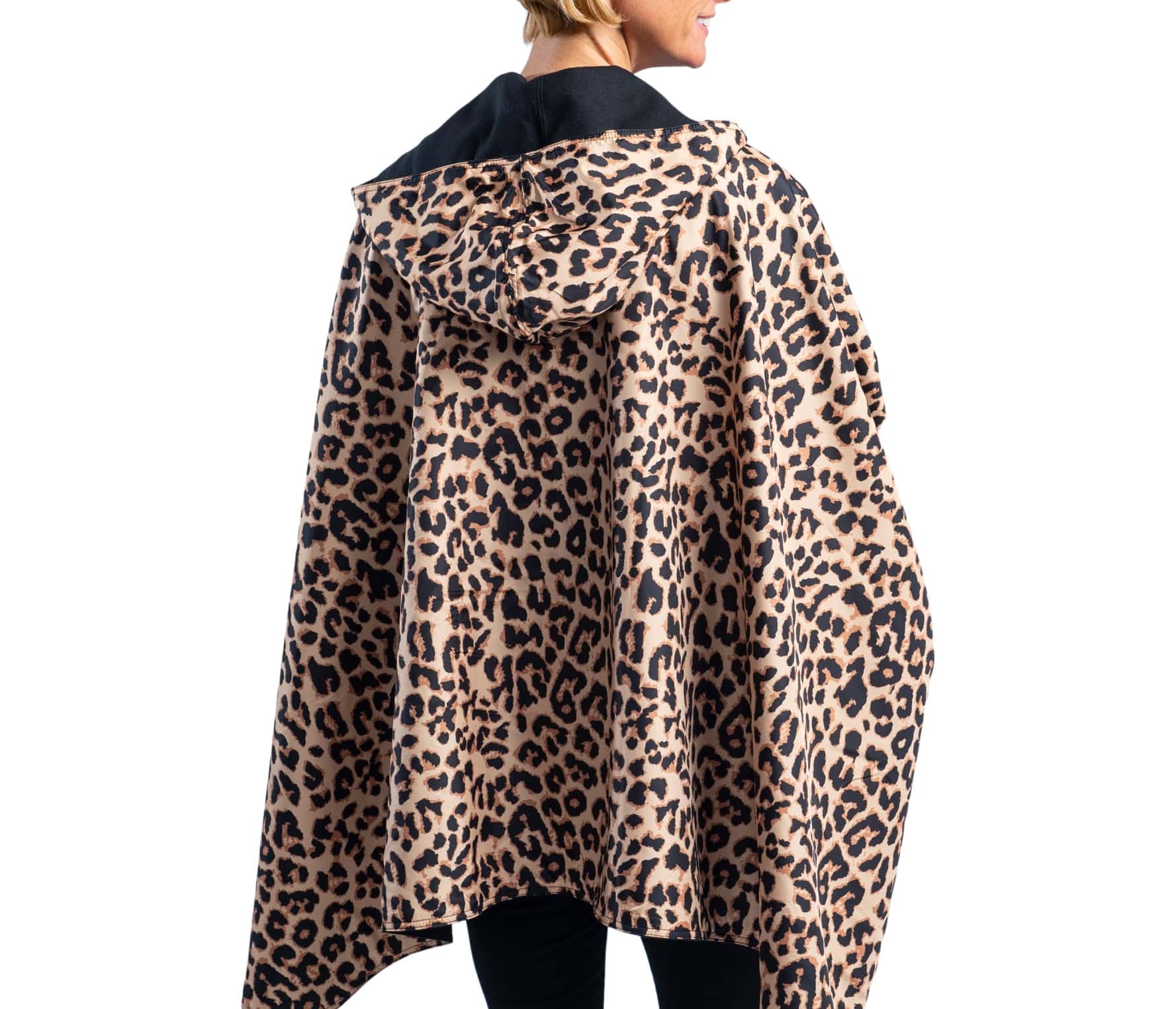 Woman wearing a WarmCaper Warm Black & Rainproof Leopard lined rain and travel cape by RainCaper.